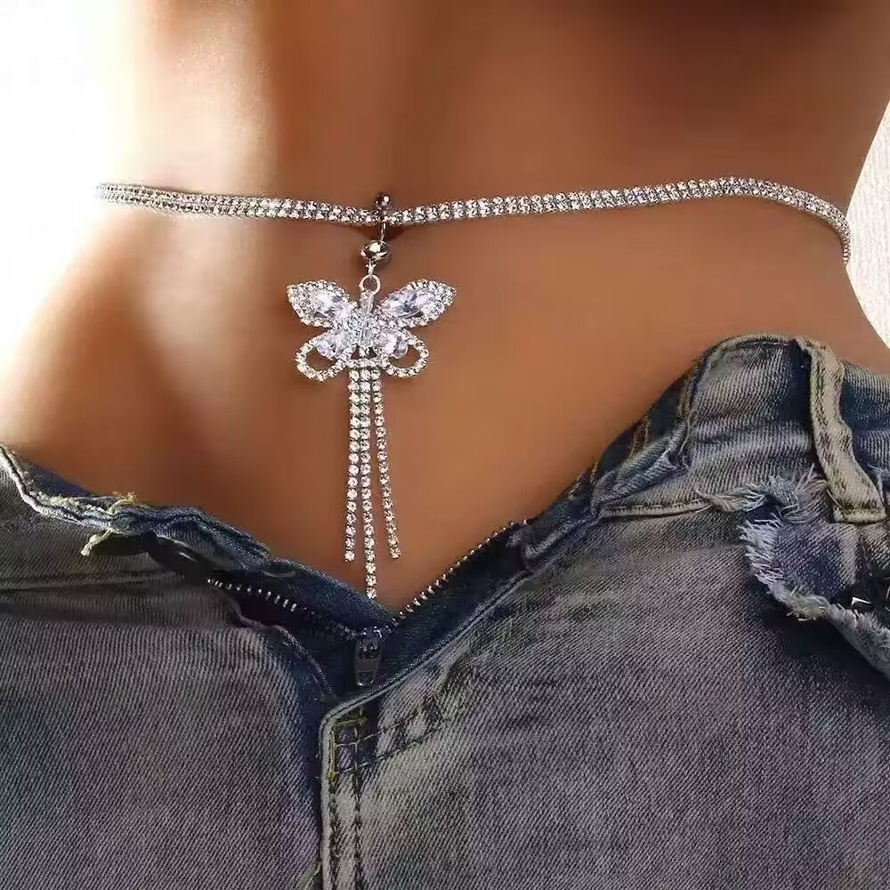 Woman wearing a romantic crystal butterfly dangle belly button ring with double layer waist chain.