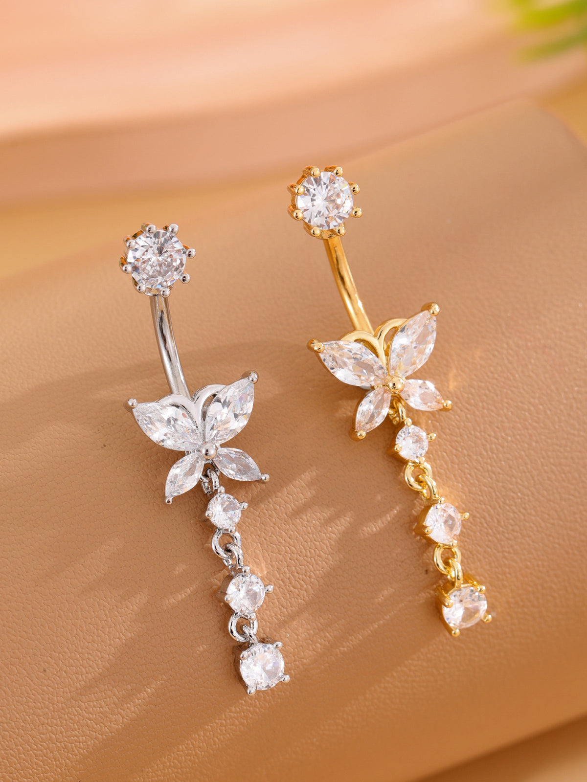 Two butterfly dangle belly button rings comparing silver-tone and gold-tone colors