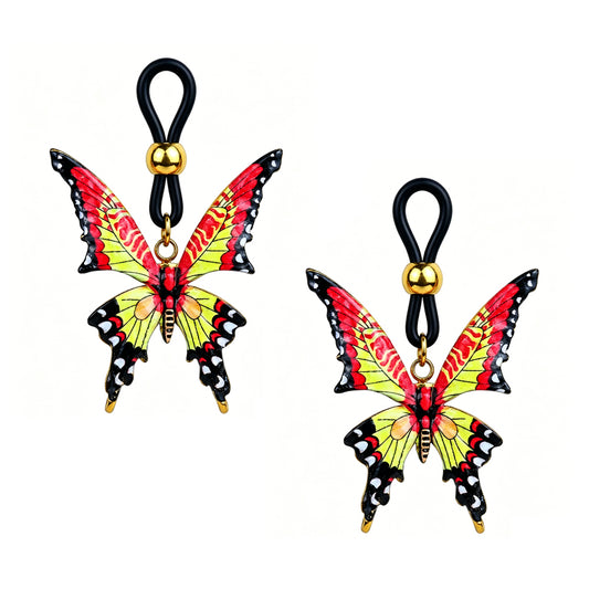 A matching pair of adjustable fake nipple rings shaped as alternative punk style butterflies with red, yellow, and black details, showcasing the non-piercing custom-fit slider bead mechanism against a crisp white studio background.