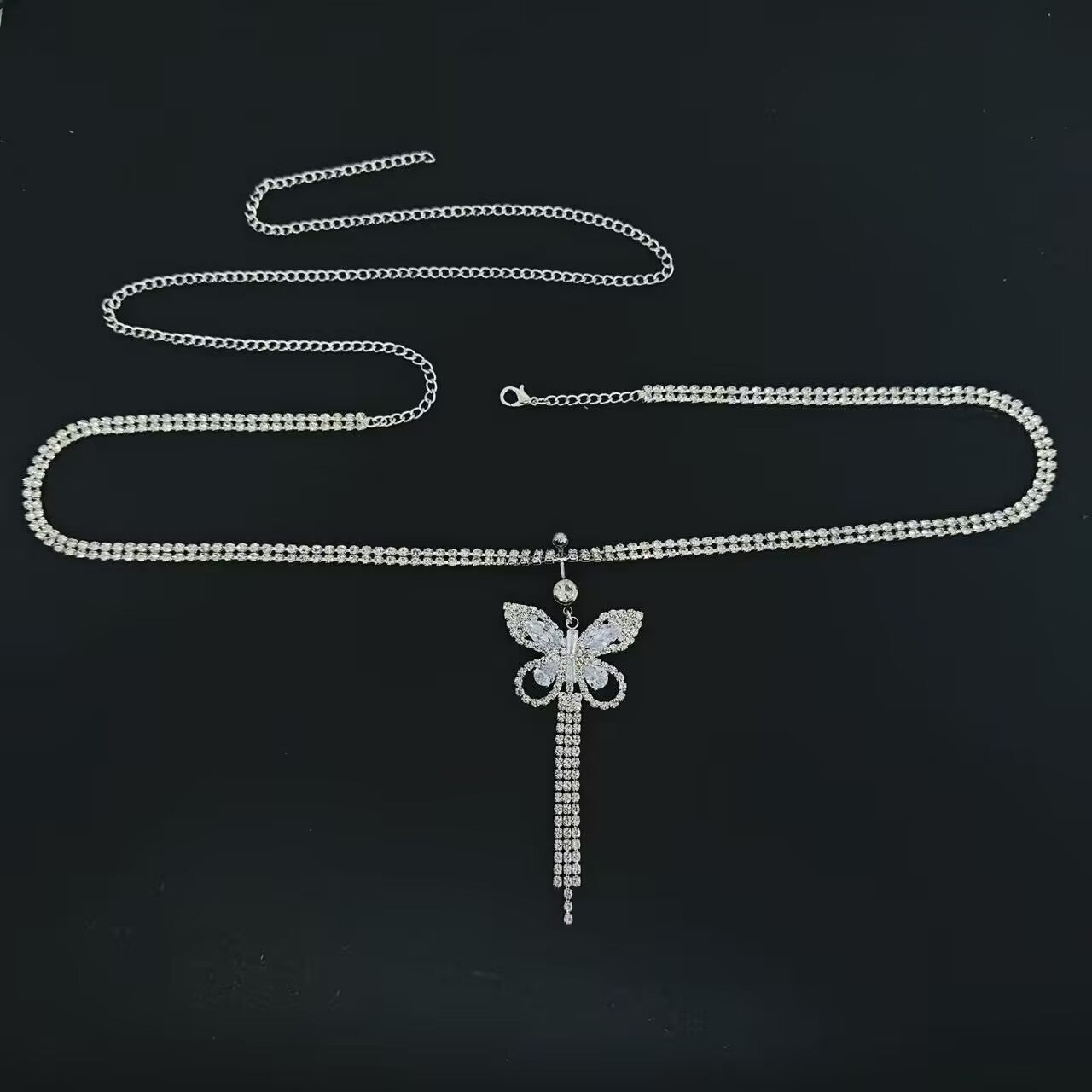 Full length product view of crystal butterfly tassel belly button ring attached to adjustable waist chain.