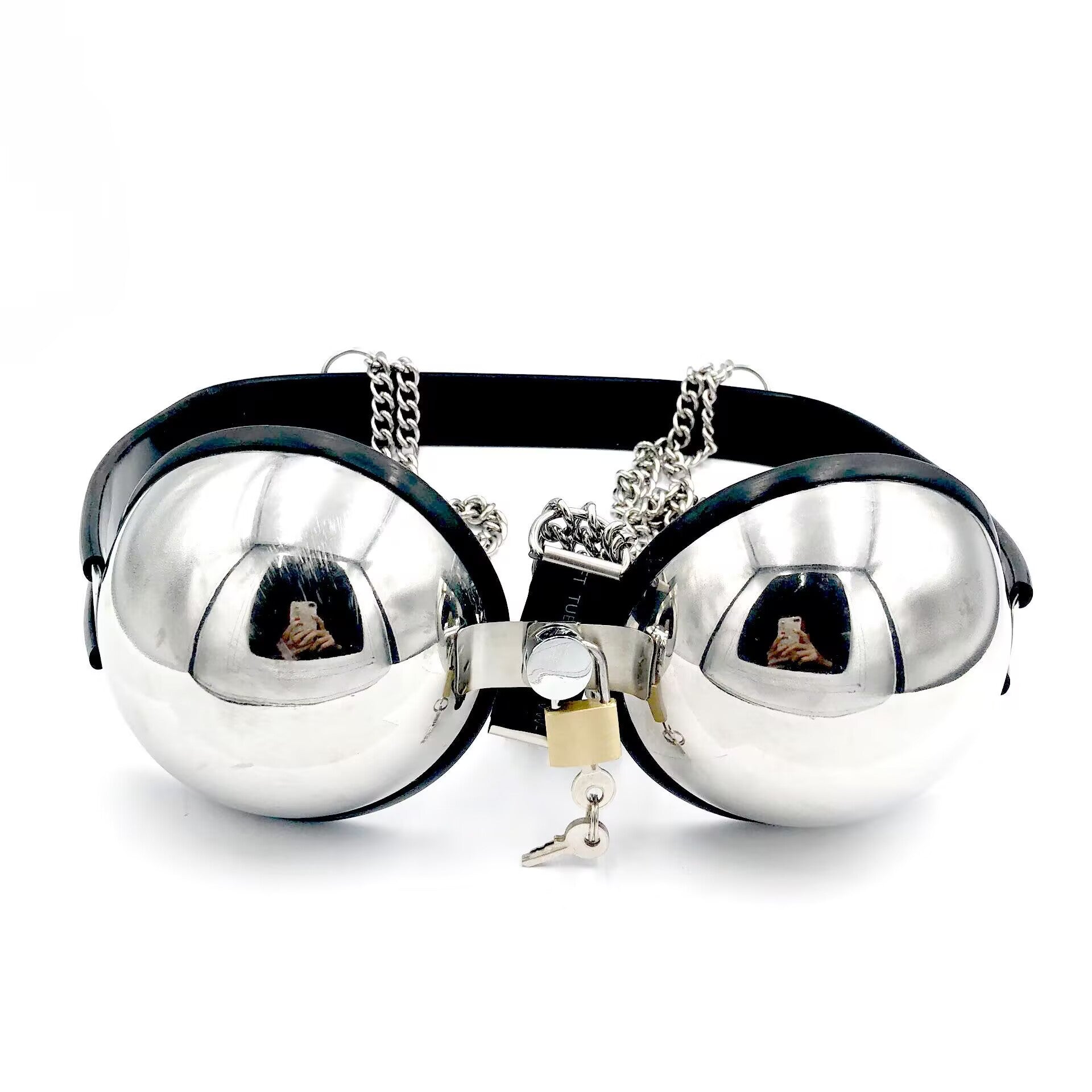 Close up details of the lockable metal bra harness mechanism featuring a brass padlock with keys hanging from the center connector.