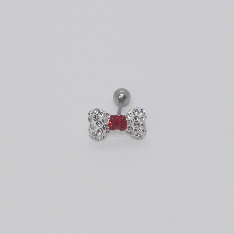 One clear rhinestone bow earring with a red rhinestone center and silver-tone ball end.