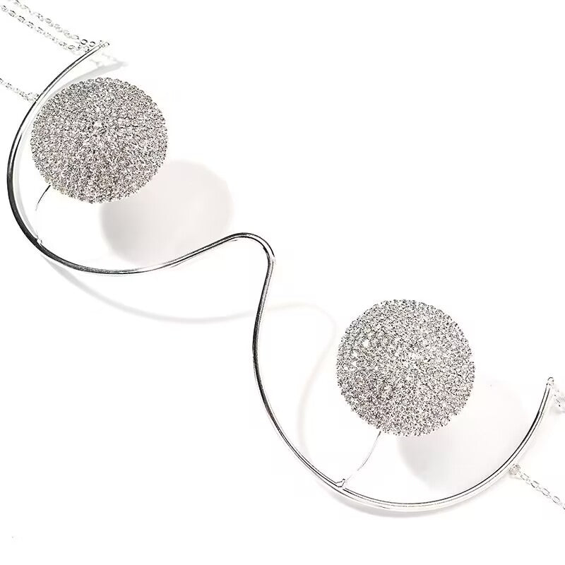 Close-up shot of an exotic silver rhinestone cupless bra body chain highlighting the detailed diamond encrusted circles and metallic underwire curve.