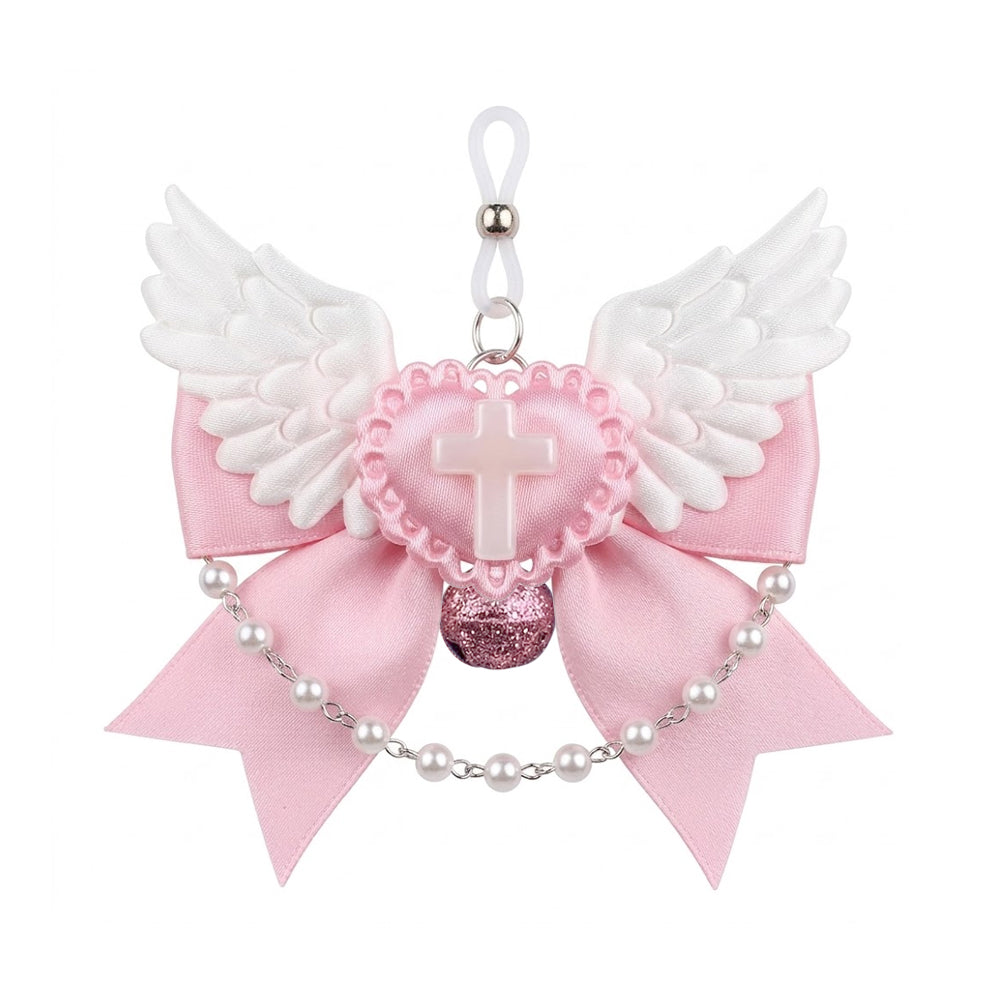 Front view of a pink satin bow nipple clamp featuring white angel wings, a pearlescent cross heart, and a pink glitter bell.
