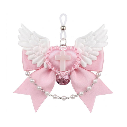 Front view of a pink satin bow nipple clamp featuring white angel wings, a pearlescent cross heart, and a pink glitter bell.