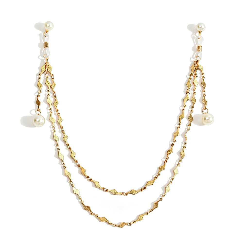 Double-layered gold geometric body chain with dangling faux pearls on a pure white background, showcasing a non-pierced breast ornament design.