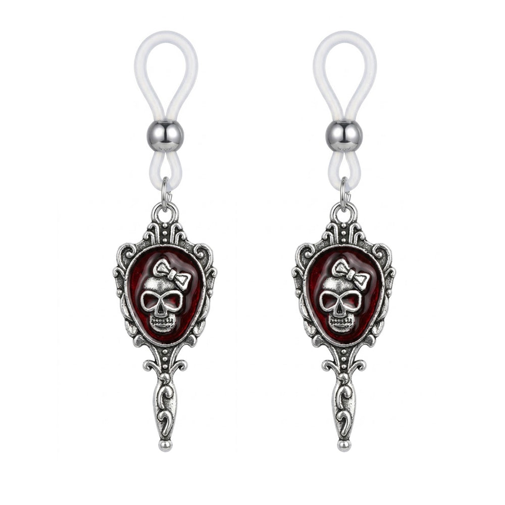 A pair of non-piercing gothic skull nipple clips with dark red enamel background and silver ornate Victorian style frames.