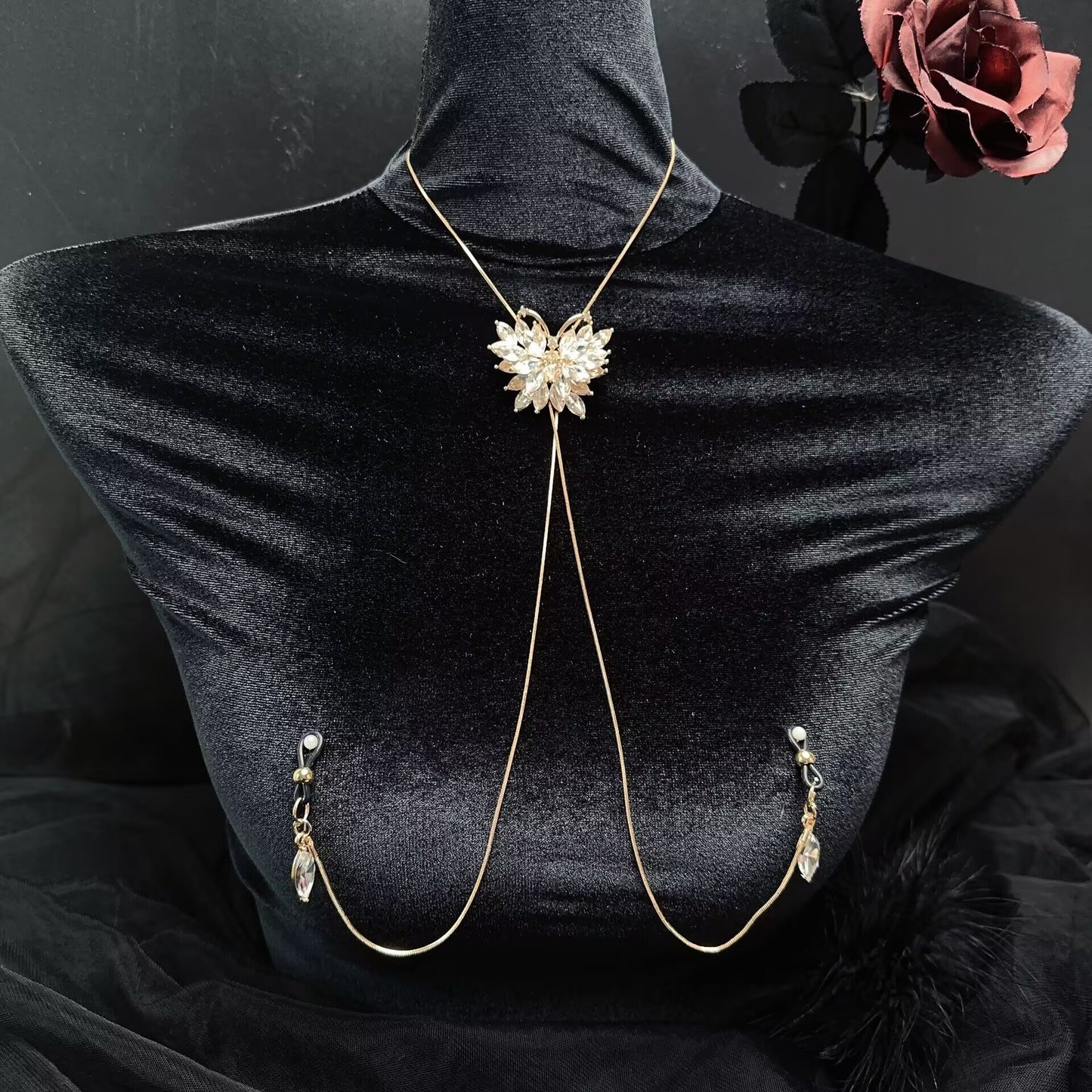 Gold non-pierced nipple clamp body chain harness with sparkling crystal butterfly pendant displayed on black mannequin