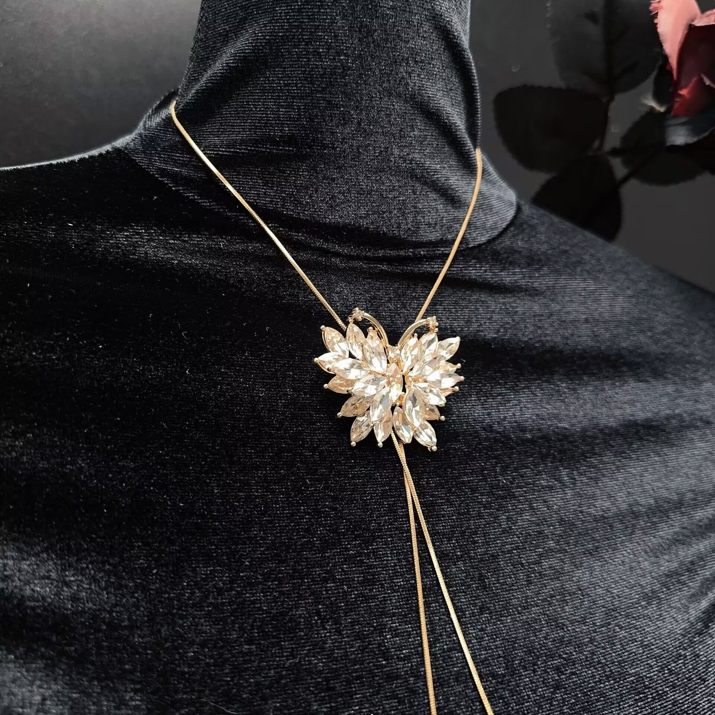 Close-up of marquise crystal butterfly centerpiece on gold snake chain body harness