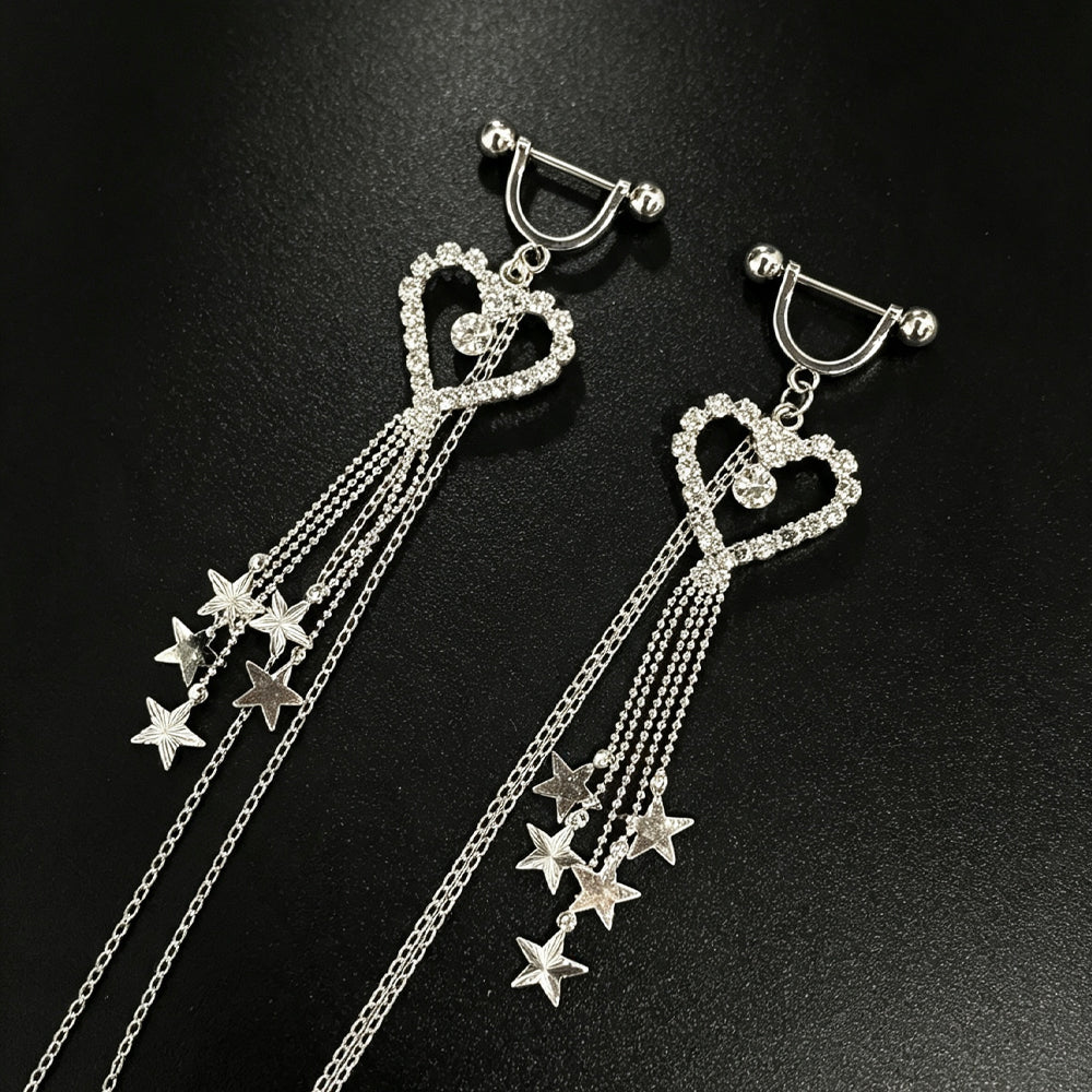 Close-up view of silver heart nipple shields featuring cubic zirconia crystals and multi-strand star dangle chains.