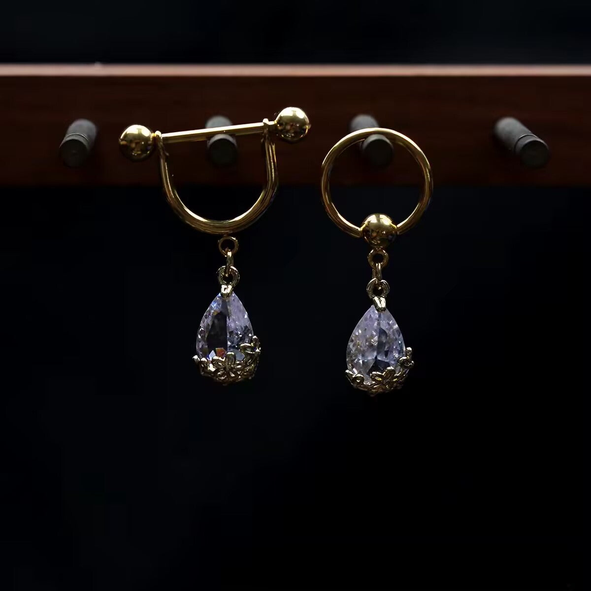 Gold tear drop crystal pierced nipple jewelry showing barbell shield and captive bead ring styles