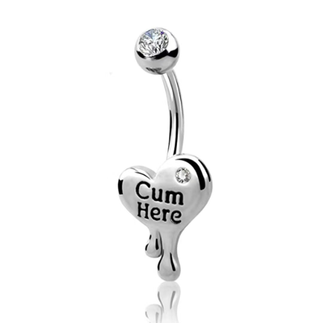 An edgy silver curved barbell belly button ring with a metallic melting dripping heart charm engraved with the words Cum Here.