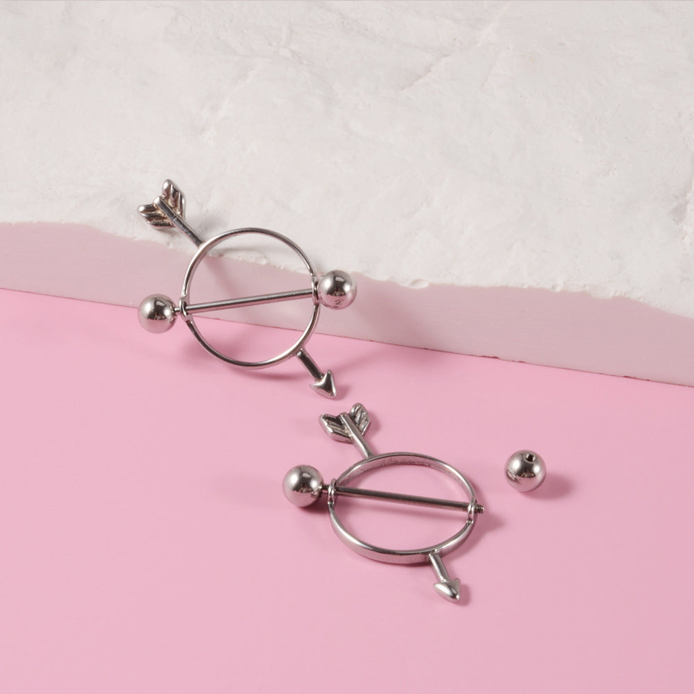 A minimalist silver-toned Cupid's arrow nipple shield featuring a sleek circle and a barbell with arrowhead and fletching.