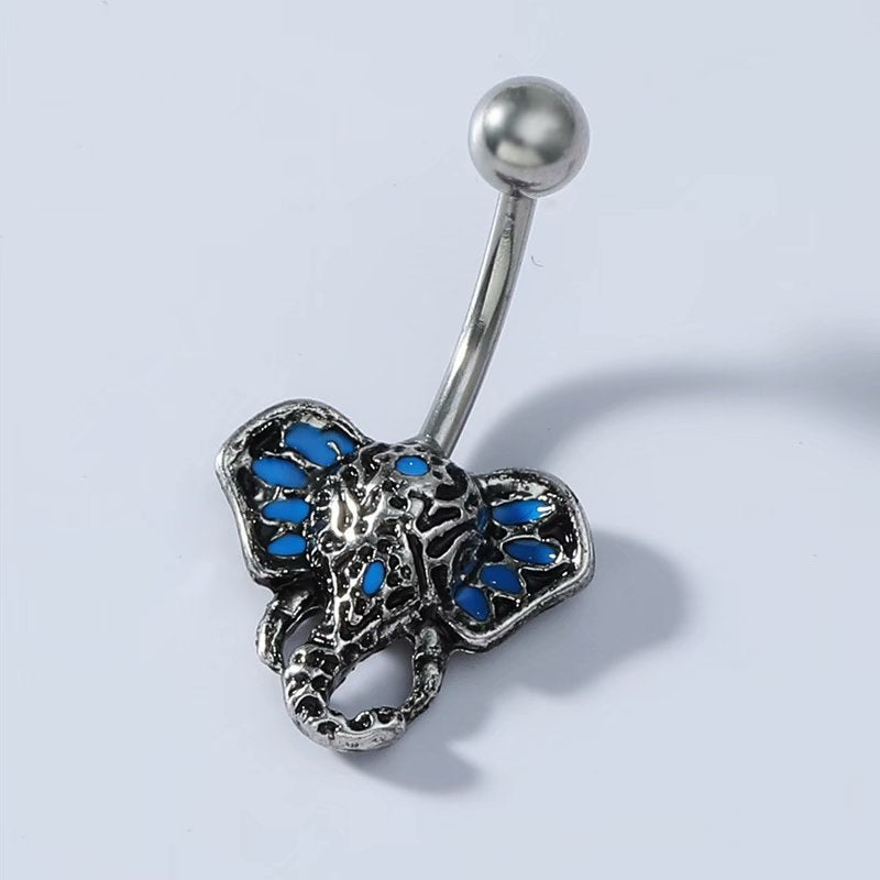 Close-up view of tribal elephant navel piercing jewelry with antique finish and turquoise detailing