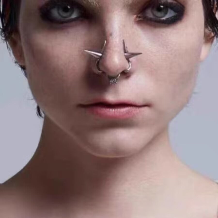 Front view close-up of a non-piercing double nose ring with spikes and hanging dangle accent