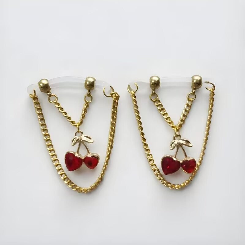 Dangle fake nipple rings with cute red heart cherry charms attached to gold chain loops with clear transparent bands.