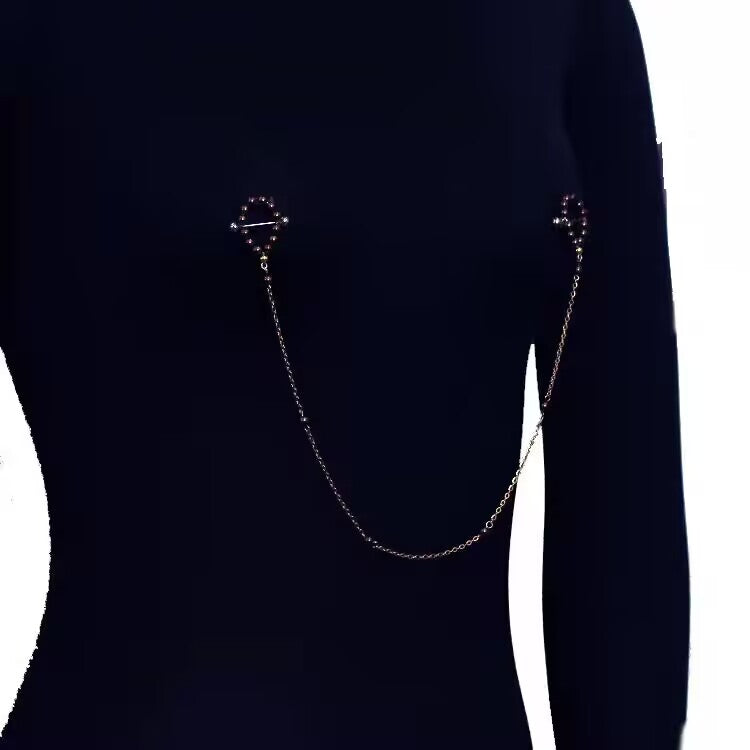 Model wearing a connected dark bronze pearl nipple chain body jewelry set.