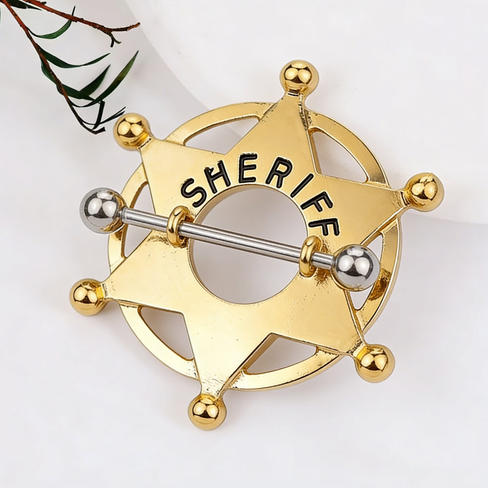 Close-up of a decorative gold sheriff star nipple piercing jewelry.