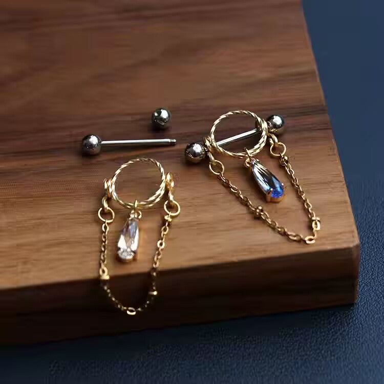 Nipple shield ring jewelry demonstrating the detachable straight barbell bar and screw balls.