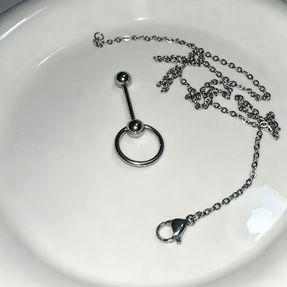 Flat lay product photo of a 316L stainless steel tongue barbell, O-ring, and a detached chain with a lobster clasp on a clean white background.