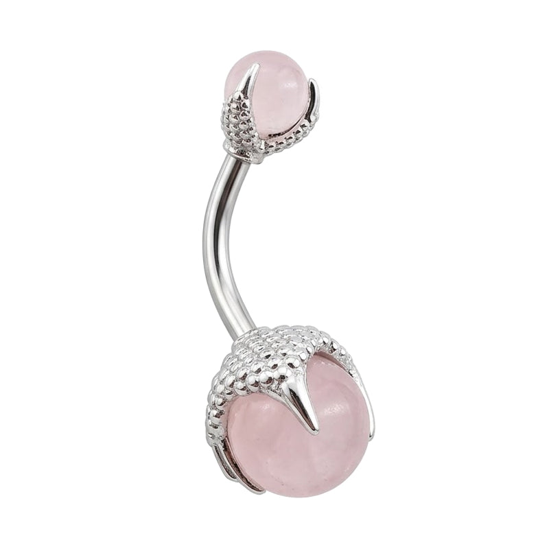 Gothic dragon claw belly ring holding a soft pink crystal sphere, featuring top and bottom detailed claw accents.