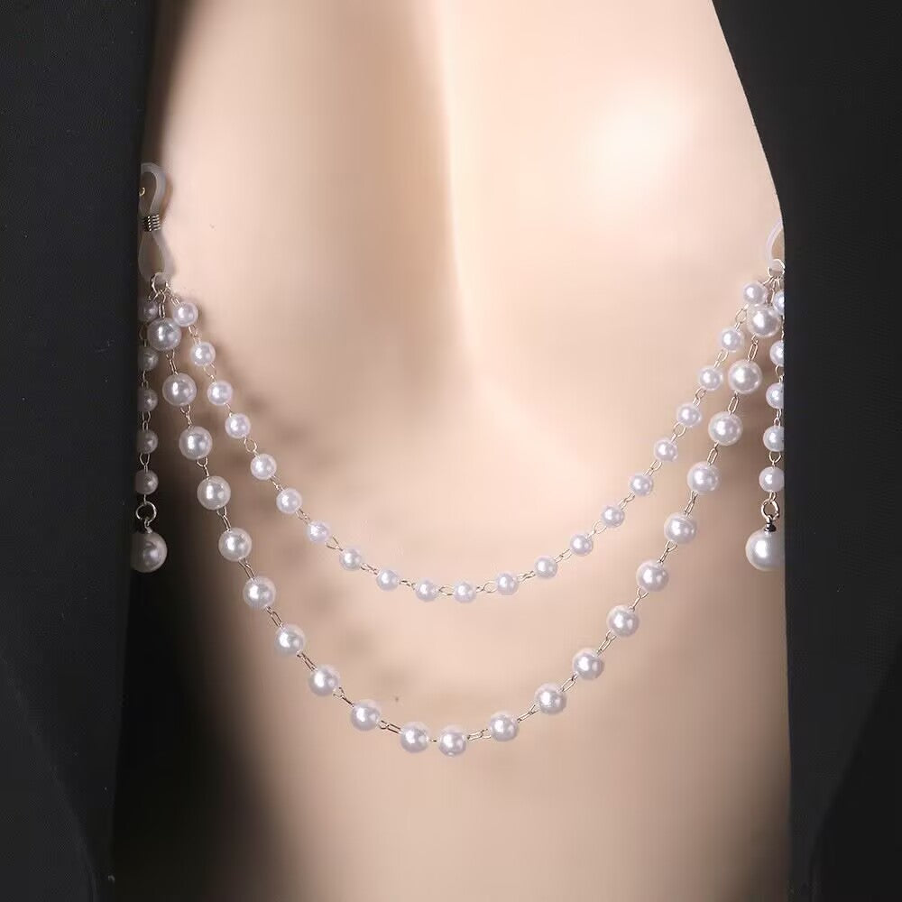 Close-up of a model wearing a double-layer pearl non-piercing nipple chain inside a black blazer, showcasing the alternative coquette fashion and body jewelry aesthetic.
