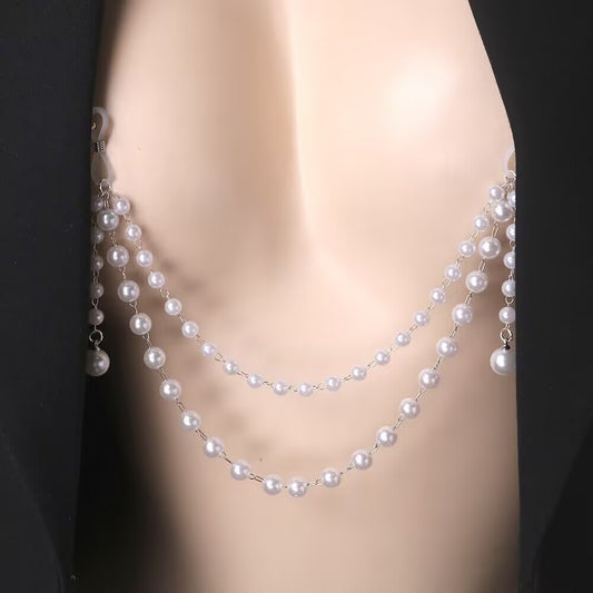 Close-up of a model wearing a double-layer pearl non-piercing nipple chain inside a black blazer, showcasing the alternative coquette fashion and body jewelry aesthetic.