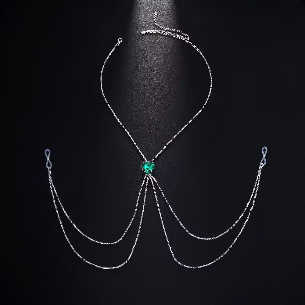 Emerald green heart crystal non-pierced nipple harness chain jewelry laid out on a dark background showing silicone loop connectors.
