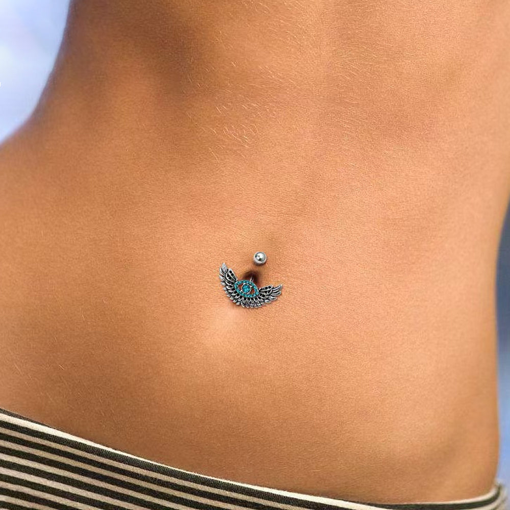 Two gothic style evil eye belly rings displayed on a white surface showing 3D details.