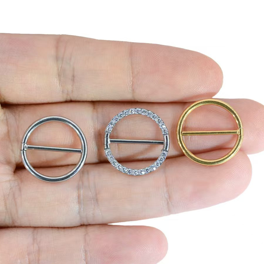 Three different styles of solid F136 titanium hinged nipple shields held on fingers for size comparison.