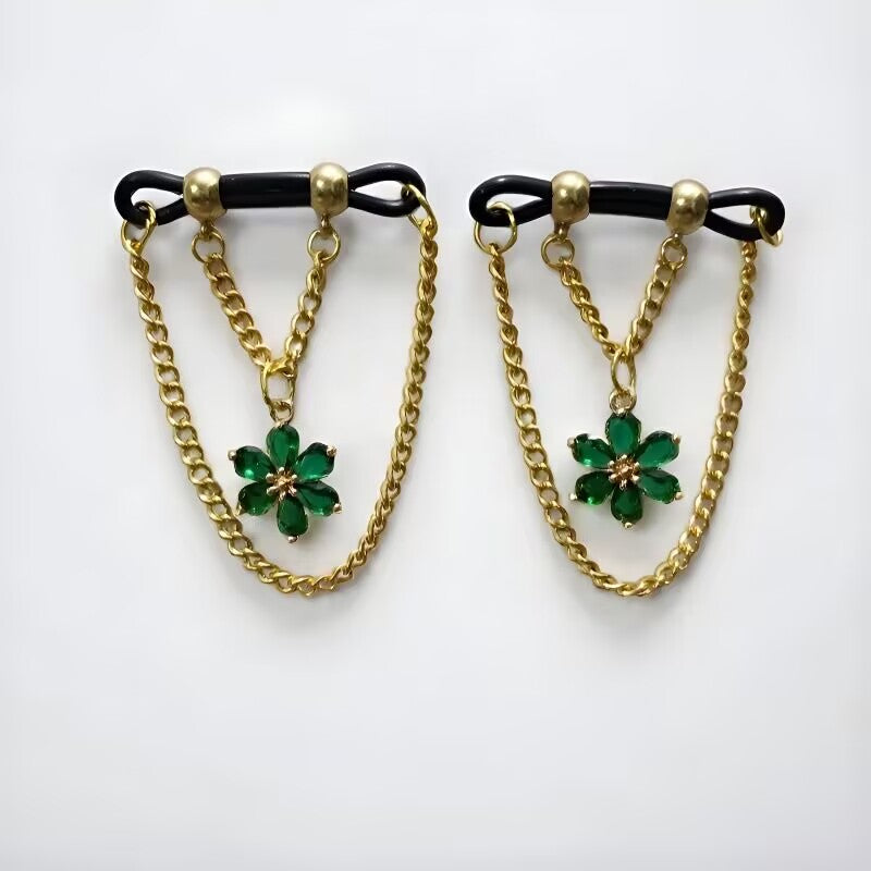 Fake nipple rings pair with green marquise crystal flower charms and gold dangle chains on adjustable loops.