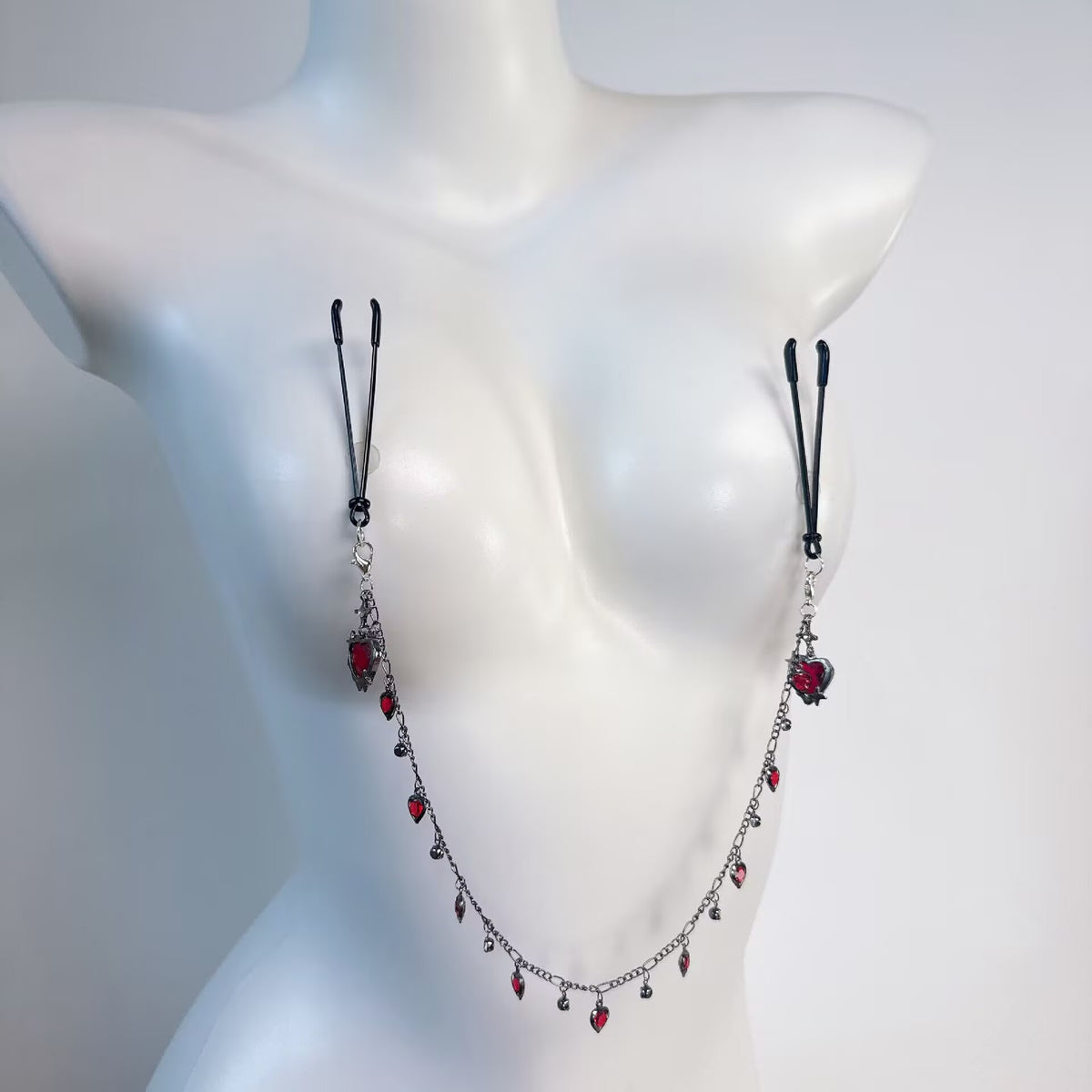 Non-pierced adjustable nipple loop clamps attached to red crystal heart hanging chain