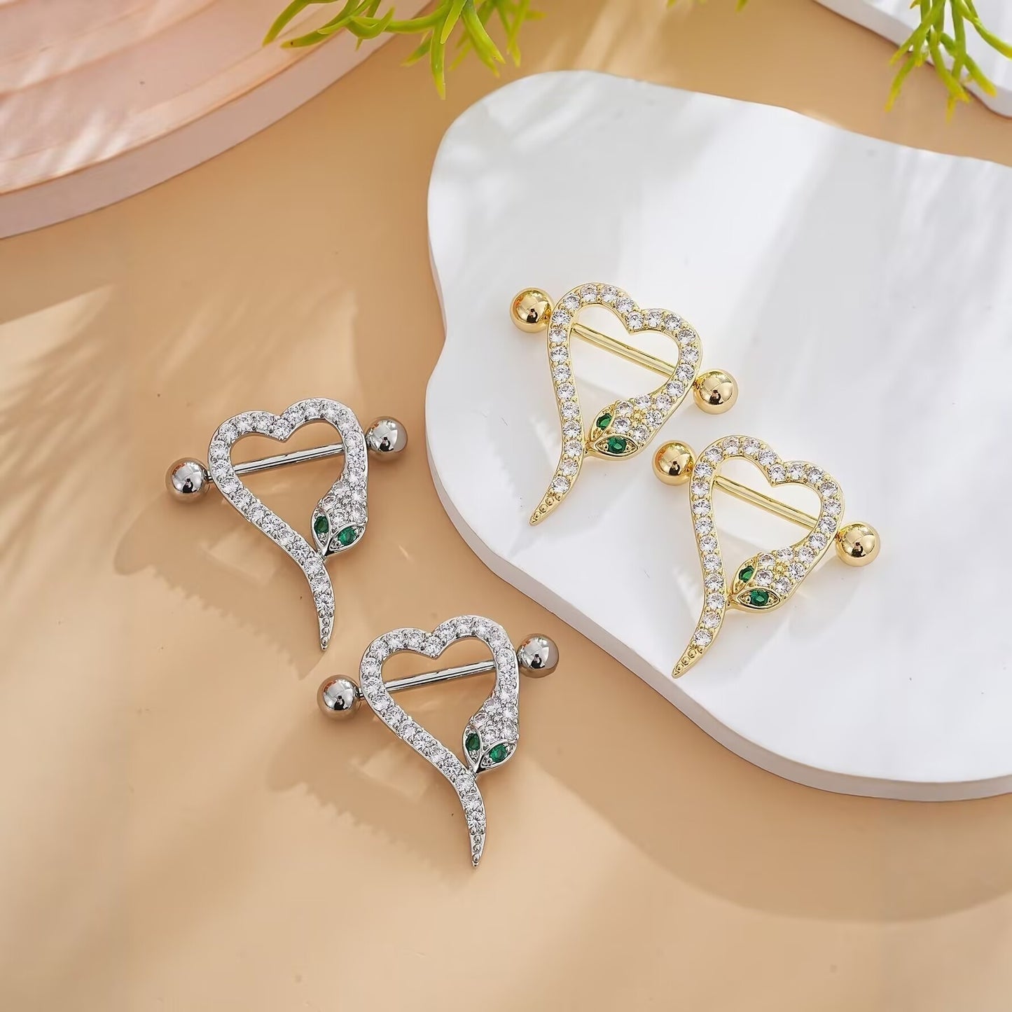 Group shot showcasing both gold and silver versions of the heart snake nipple shield.