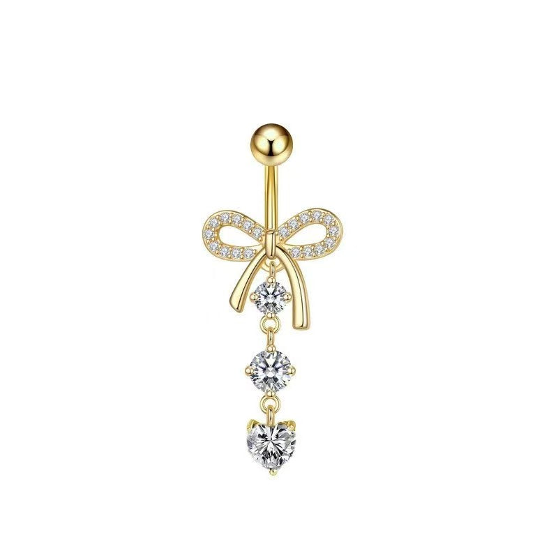 Gold bowknot belly piercing jewelry with clear heart-shaped crystal.