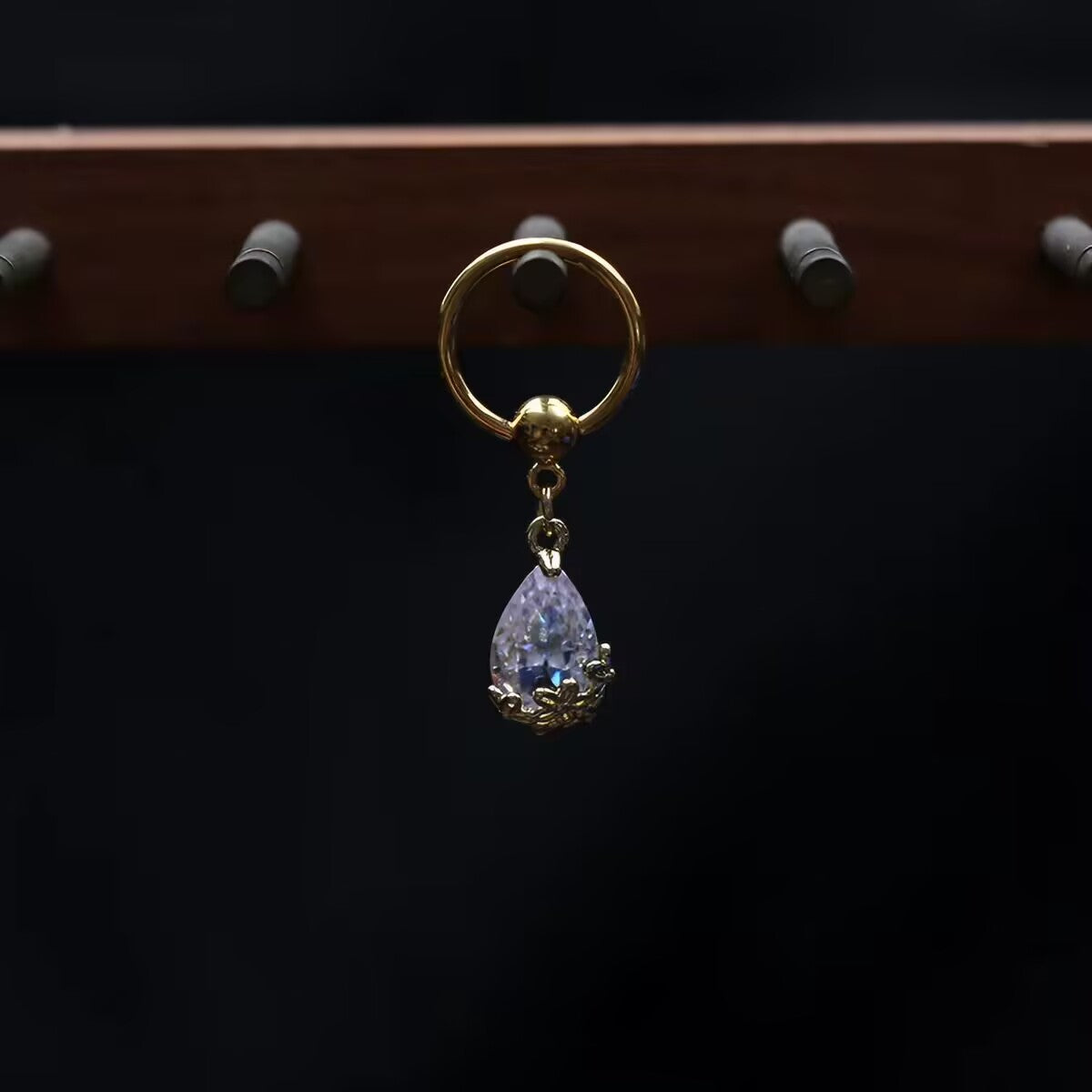 Pierced captive bead hoop nipple ring featuring dangling clear teardrop crystal pendant