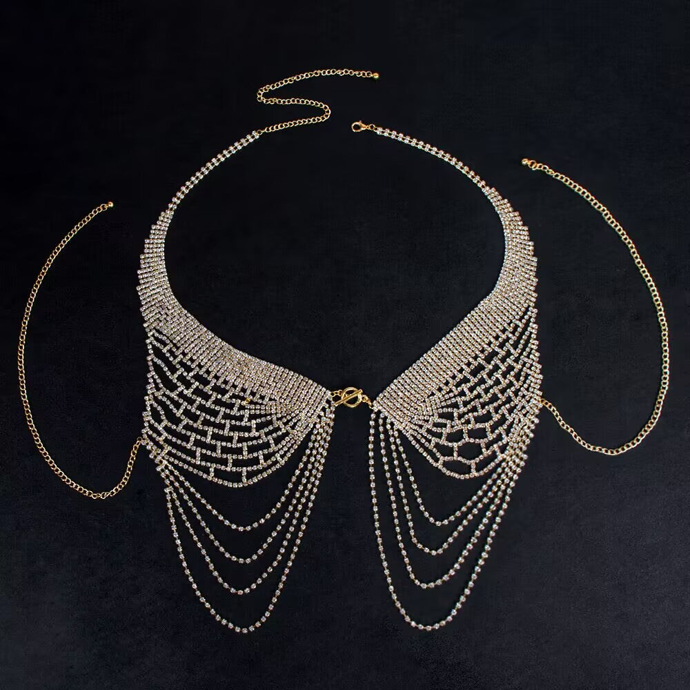 Gold crystal bra body chain displayed on a dark background showing sparkling rhinestones and adjustable halter strap.