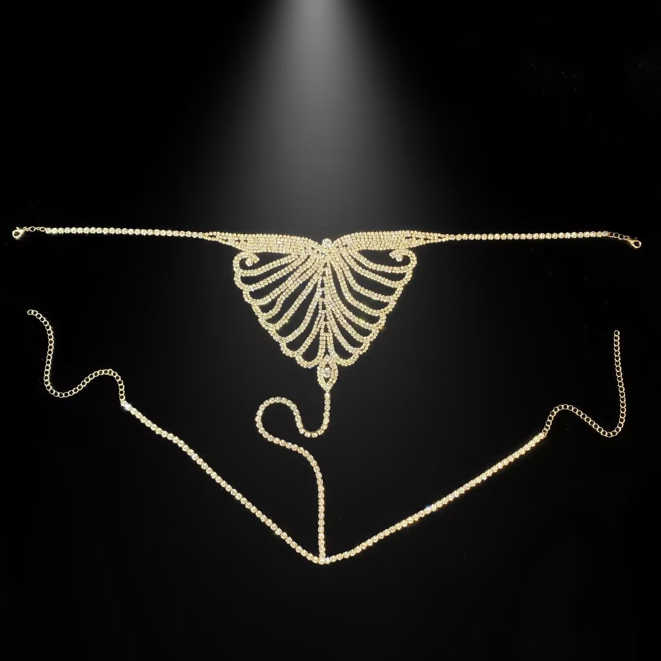 Gold crystal butterfly thong body chain laid flat displaying full chain pattern.