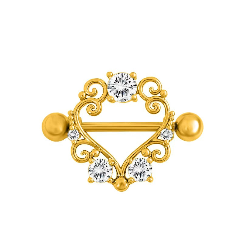 Ornate gold heart nipple shield jewelry featuring intricate scrolling design and clear stones.