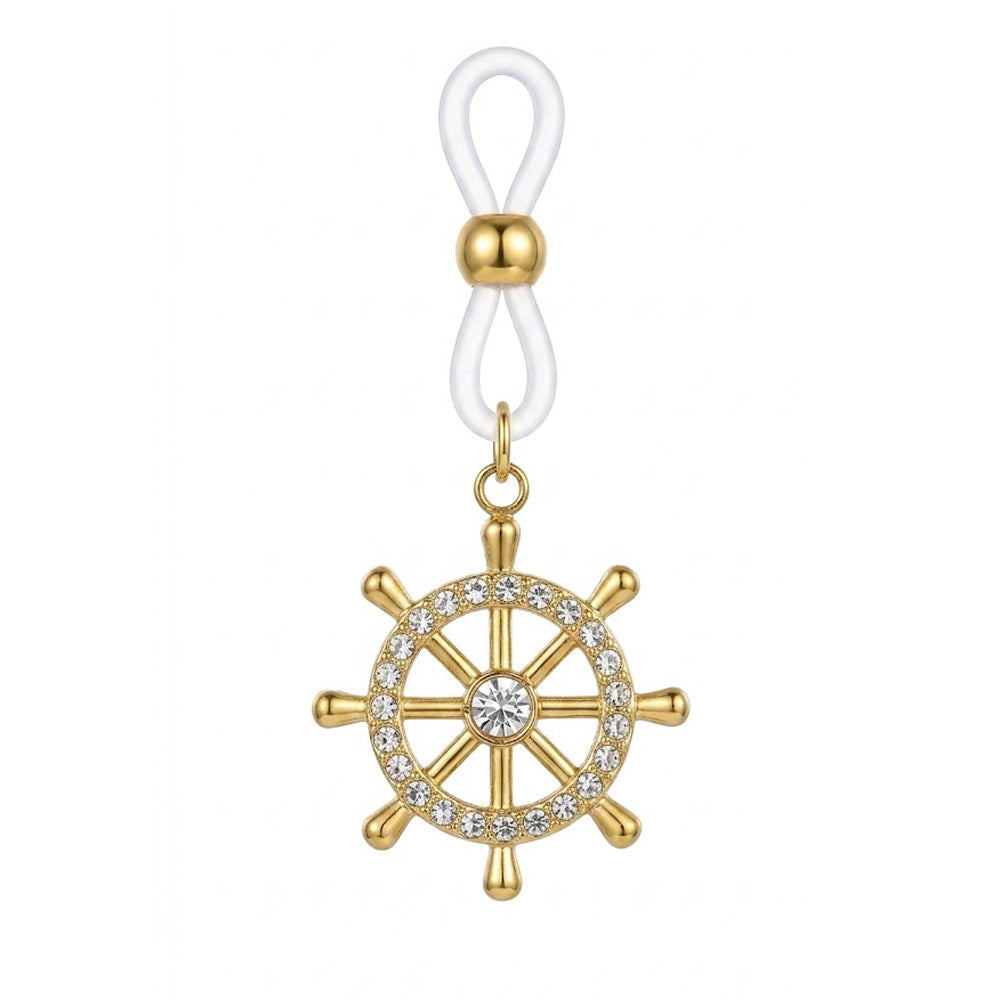 A high-definition close-up shot of a single gold non-piercing nipple ring featuring a nautical ship wheel pendant paved with sparkling crystal rhinestones, hanging from an adjustable white silicone loop on a pure white background.