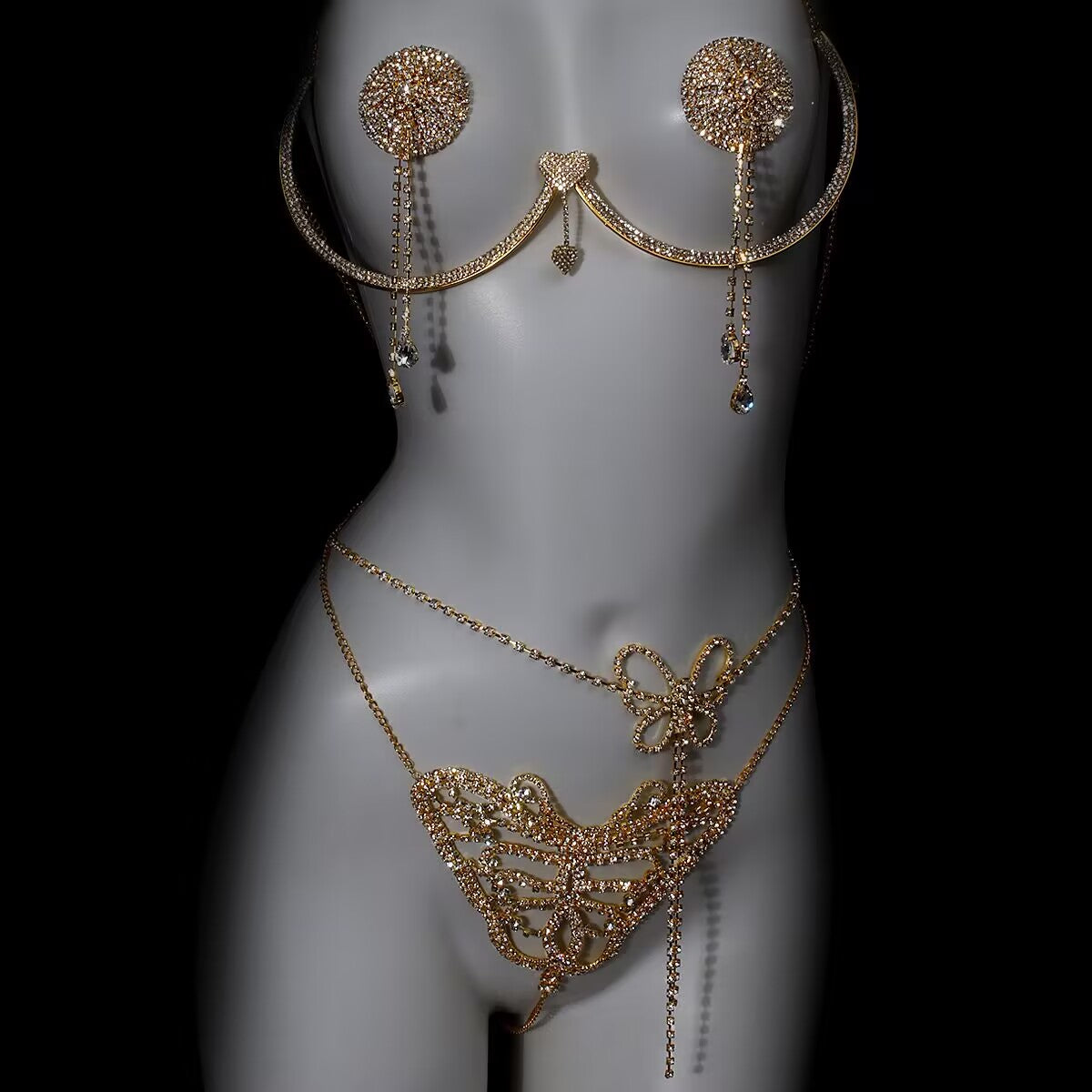 Gold rhinestone body jewelry 3-piece set with breast bracket, nipple tassels, and butterfly waist chain displayed on mannequin.