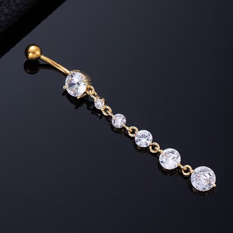 Gold curved barbell navel ring with shimmering round CZ tassel drop.