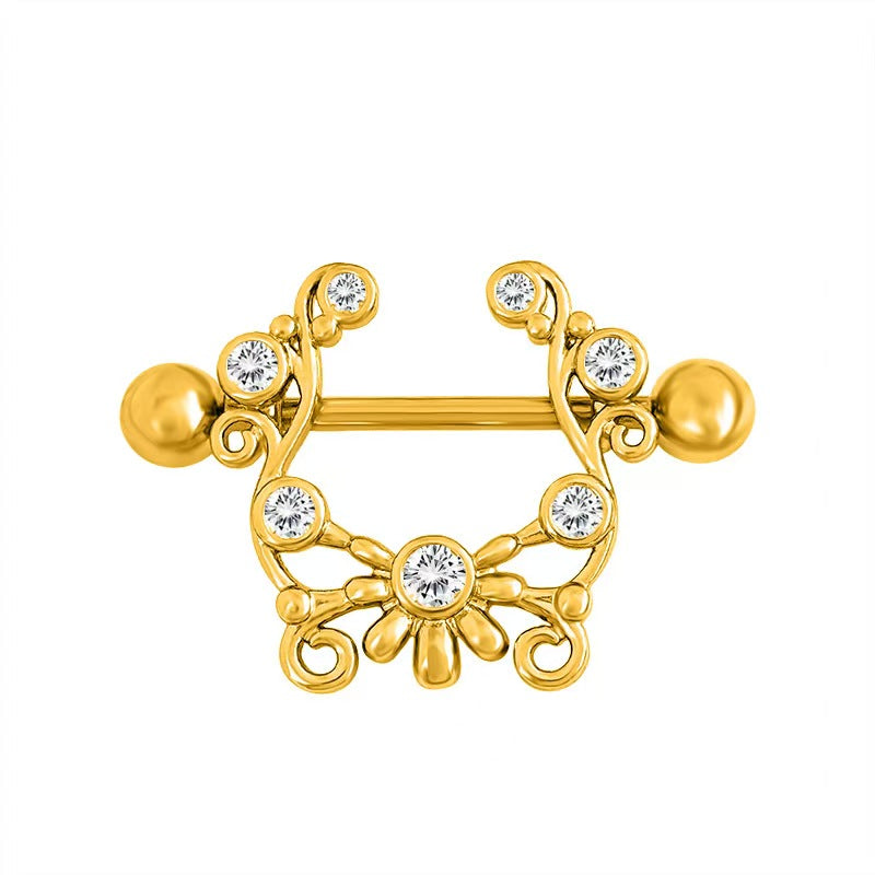 Elegant gold-toned nipple shield featuring vintage scroll patterns and gemstones.