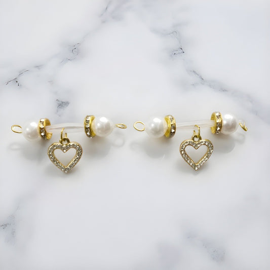 Matching pair of gold-tone non-piercing nipple jewelry with white pearl-look ends and sparkling open-heart charms