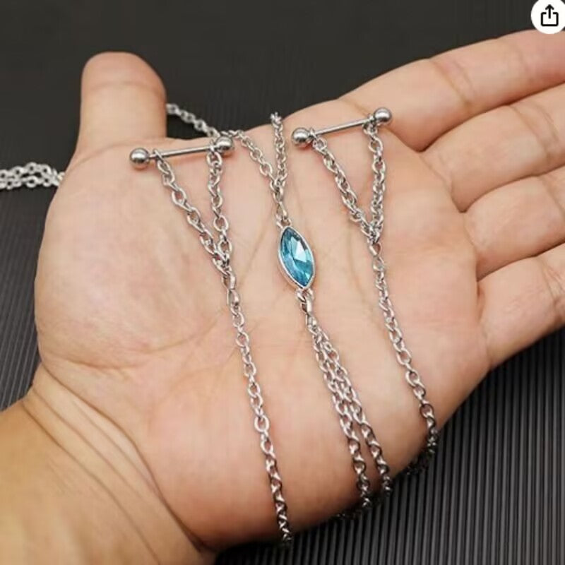 A person holding the silver-colored alternative aesthetic nipple piercing jewelry chain, highlighting the multi-layer links and the sparkling blue marquise crystal.