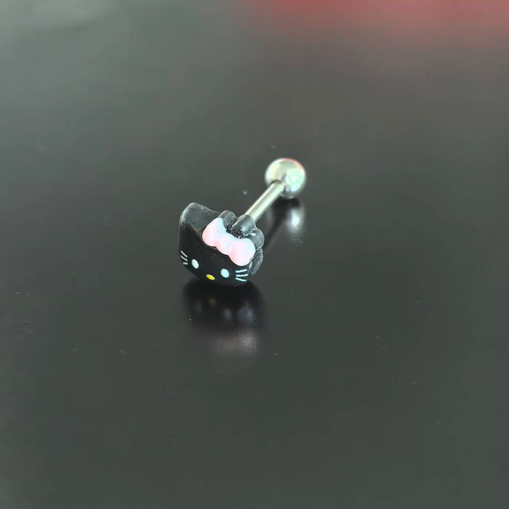 Edgy goth black kitty tongue ring barbell with pink bow detail for alt body jewelry style.