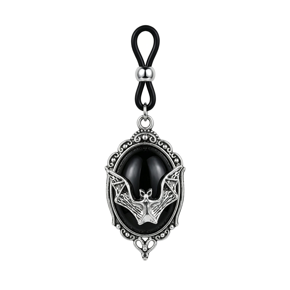 Front view of a single Gothic bat non-piercing nipple clamp with an adjustable black rubber loop, sliding silver bead, and a vintage silver frame holding an oval black cabochon on a pure white background.