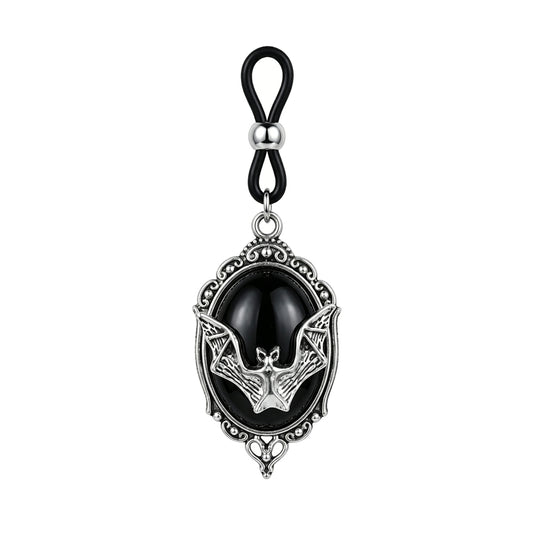 Front view of a single Gothic bat non-piercing nipple clamp with an adjustable black rubber loop, sliding silver bead, and a vintage silver frame holding an oval black cabochon on a pure white background.
