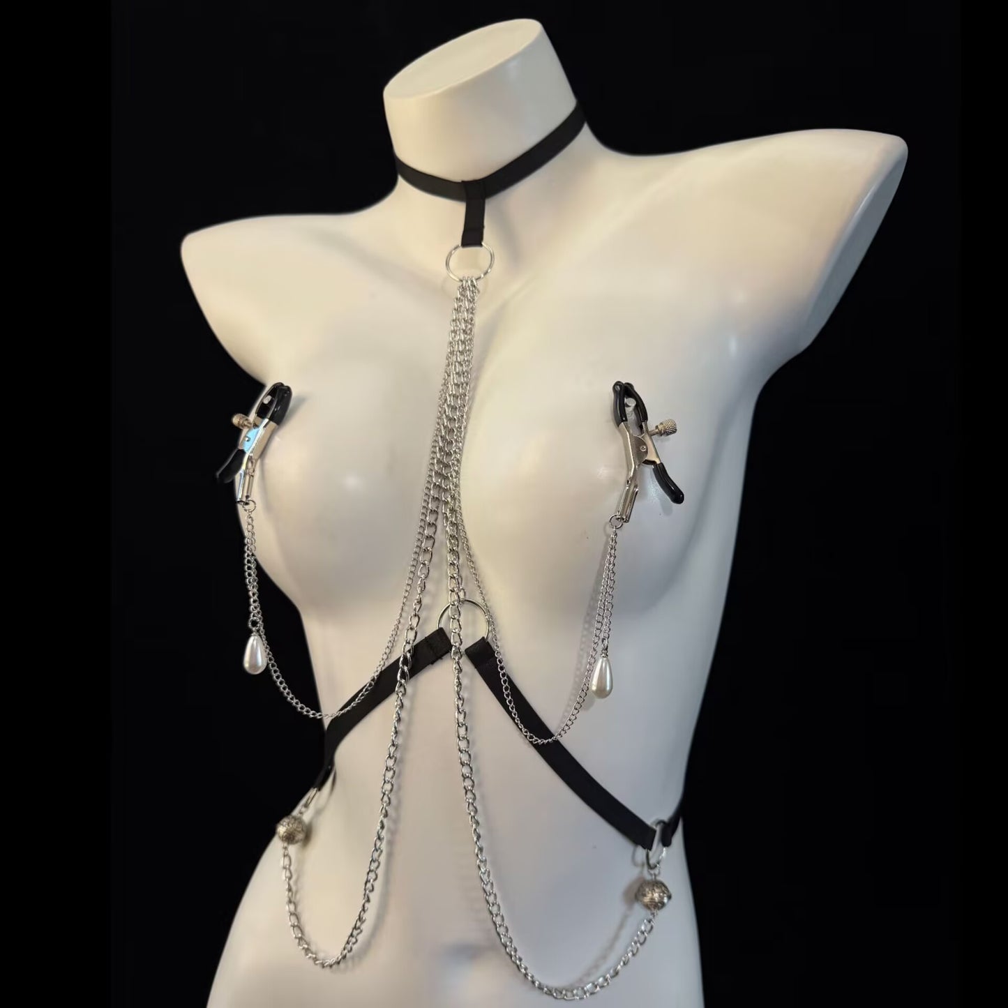 Full front view of black strap body harness featuring layered silver chains and screw-tight nipple clamps.