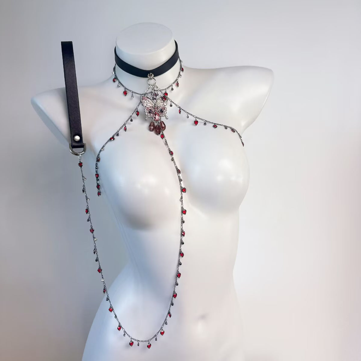 Gothic rhinestone butterfly choker shoulder chain harness with black leather leash on mannequin