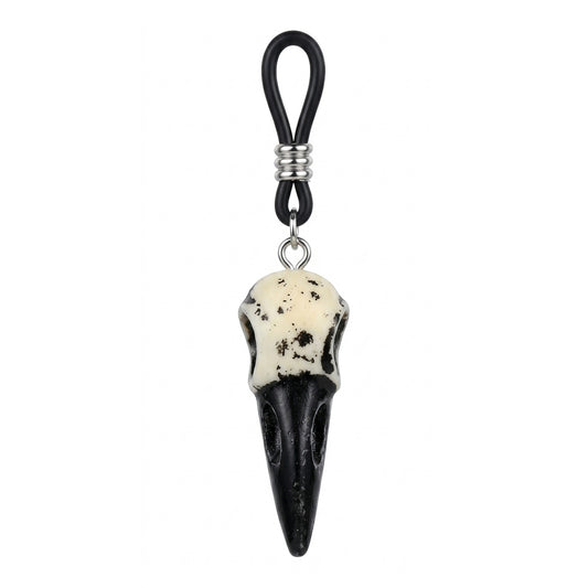 Close-up of a single weathered white and black crow skull pendant attached to an adjustable black nipple loop.